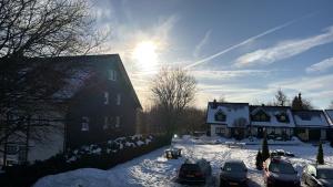 a group of cars parked in a snow covered yard at Ferienwohnung Fichtenweg in Winterberg
