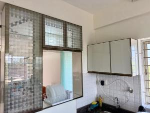 a kitchen with a sink and a shower and a window at Between Tides nd Toasts Udupi Manipal in Manipal +17 photos