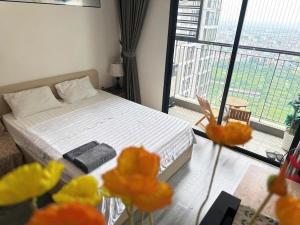 a bedroom with a bed and a large window at R1 Studio Ruby Zenpark in Gia Lâm Pho