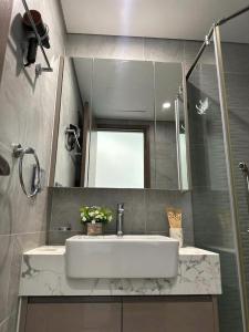 a bathroom with a sink and a mirror at R1 Studio Ruby Zenpark in Gia Lâm Pho