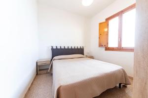 a bedroom with a bed in a white room at Summer Flat - San Foca in San Foca