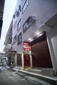 a building with a large garage door in front of it at Narayan Homestay & Guest House in Haridwār