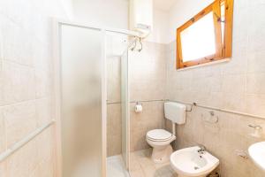 a bathroom with a shower and a toilet and a sink at Summer Flat - San Foca in San Foca +21 photos