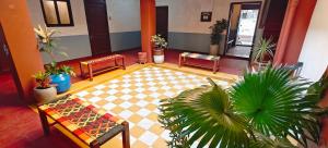a living room with benches and potted plants at Maison Monty in Pondicherry