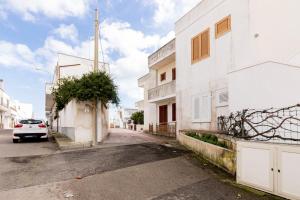 a car parked on a street next to a white building at Summer Flat - San Foca in San Foca