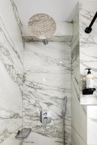 a bathroom with a marble shower with a sink at Minavra Hotel in Athens +74 photos
