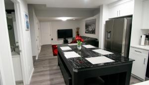 a kitchen with a black counter top in a room at Cozy Luxe Suites in Calgary