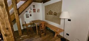 a dining room with a table and a lamp at Molin in Vigo di Fassa
