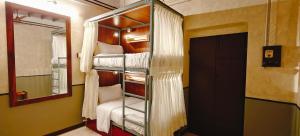 a room with two bunk beds and a mirror at Maison Monty in Pondicherry +131 photos