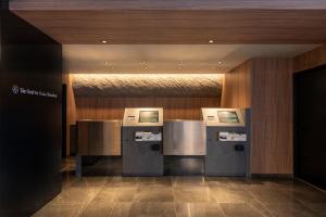 a lobby with a row of refrigerators in a building at The OneFive Osaka Shinsekai in Osaka