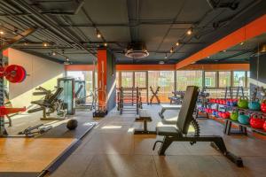 a gym with a lot of equipment in a room at HOMA Chalong Bay in Ban Klang