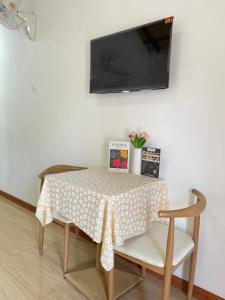 a dining room table with a polka dot table cloth at โรงแรมสบายดีรีสอร์ท in Tha Bo