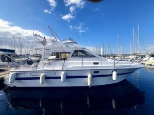 a white boat is docked in a harbor at une place au soleil in Cannes