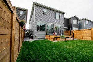 a backyard of a house with a fence at Cozy Luxe Suites in Calgary