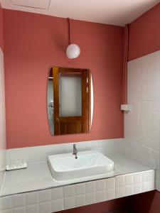 a bathroom with a sink and a mirror at T terrest Residence in Thai Muang +12 photos