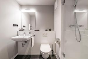 a bathroom with a toilet and a sink and a shower at ipartment Frankfurt Central Station in Frankfurt +14 photos