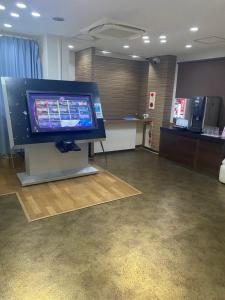 a room with a large flat screen tv on a table at ホテルラブリー淡路島 in Sumoto