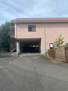 a building with a garage with a parking lot at ホテルラブリー淡路島 in Sumoto
