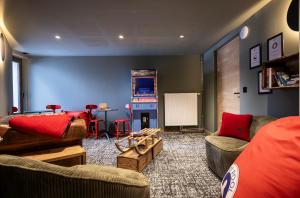 a living room with two couches and a chalkboard at TERRESENS - Les Sources de Canopée in Saint-Gervais-les-Bains