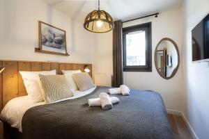 a bedroom with a bed with two towels on it at TERRESENS - Les Sources de Canopée in Saint-Gervais-les-Bains +41 photos
