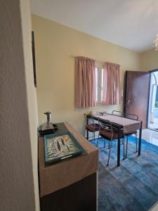a room with a table and a dining room at Appartamento Dancardi in Quartu SantʼElena