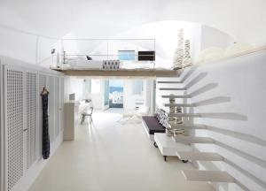 a white staircase in a room with a living room at Cloud 9 in Imerovigli