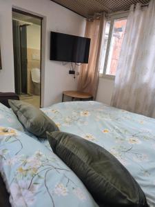 a bedroom with a bed with pillows and a television at Appartamento Dancardi in Quartu SantʼElena
