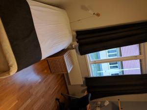a bedroom with a bunk bed and a window at Hotell Hässlö in Västerås