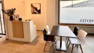 a meeting room with a table and chairs and a screen at Hotel Reigosa in Pontevedra