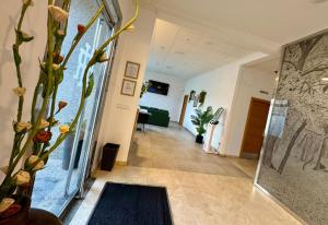 a hallway with a vase with a plant in it at Hotel Reigosa in Pontevedra