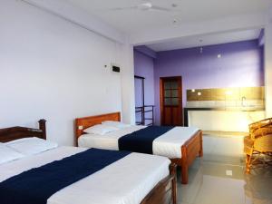 Postel nebo postele na pokoji v ubytování Randhi La Beach View Lounge + 37 fotografií