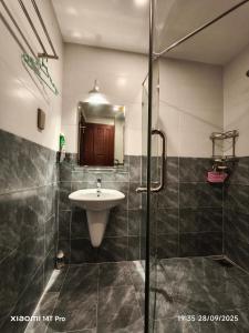 a bathroom with a sink and a shower at Long Homestay Phuc An in Ðức Hòa