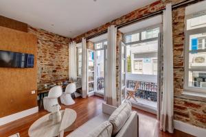 a living room with a brick wall at Stone&Light in Ermoupoli