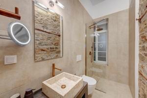 a bathroom with a sink and a toilet and a shower at Stone&Light in Ermoupoli +13 photos