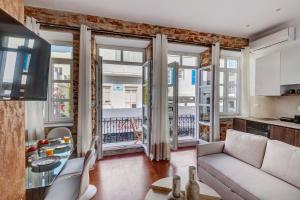 a living room with a couch and a table at Stone&Light in Ermoupoli