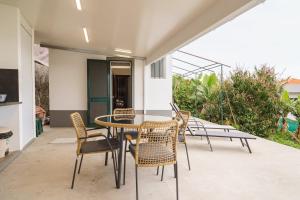 a patio with a table and chairs on a balcony at GuestReady - Funchal Hideaway with BBQ in Funchal