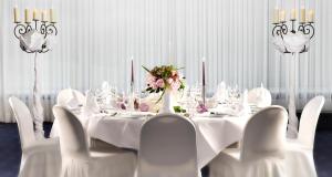a white dining room with a white table and chairs at Mercure Hotel Lüdenscheid in Lüdenscheid +87 photos