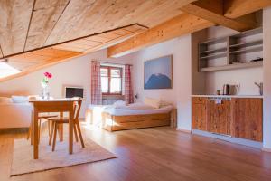 a bedroom with a bed and a table in a room at Landhaus Alger in Immenstadt im Allgäu