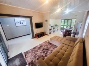 a living room with a couch and a flat screen tv at Agreste Homes in Kasama