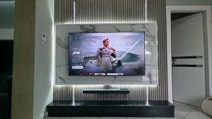 a flat screen tv on a wall in a room at Andronike's Villa in Sami