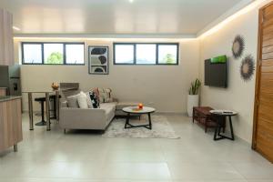 a living room with a couch and a table at Amaryllis Residences Mount Pleasant in Blantyre