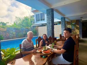 a group of people sitting at a table in a restaurant at TUBURAN Poolside in Sara