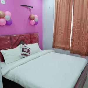 a bedroom with a bed with balloons on the wall at AG Hotel in Zirakpur