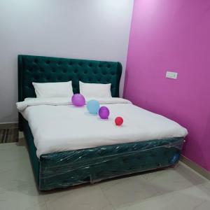 a bed with purple walls and purple balls on it at AG Hotel in Zirakpur