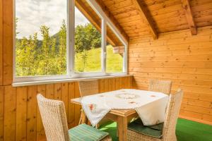 a dining room with a table and chairs in a cabin at Bambichl Hoamat in Fuschl am See