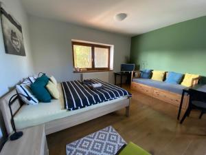 a living room with a bed and a couch at Apartmán u Horynů - Sadová in Česká Třebová