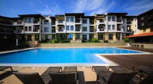 a large swimming pool in front of some buildings at Апартаменти Литорал in Chernomorets