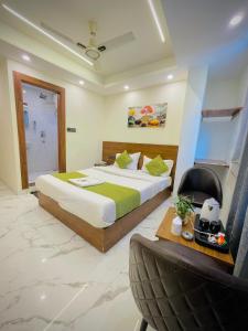 a bedroom with a bed and a chair in it at Hotel Mount View Inn with terrace Ganga view- near Laxman jhula, Tapovan Rishikesh in Rishīkesh +34 photos