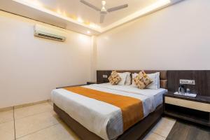 a bedroom with a large bed in a room at FabHotel Prime The Bentree in Bhopal