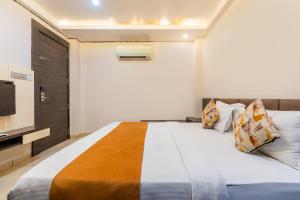 a bedroom with a large bed and a television at FabHotel Prime The Bentree in Bhopal +42 photos